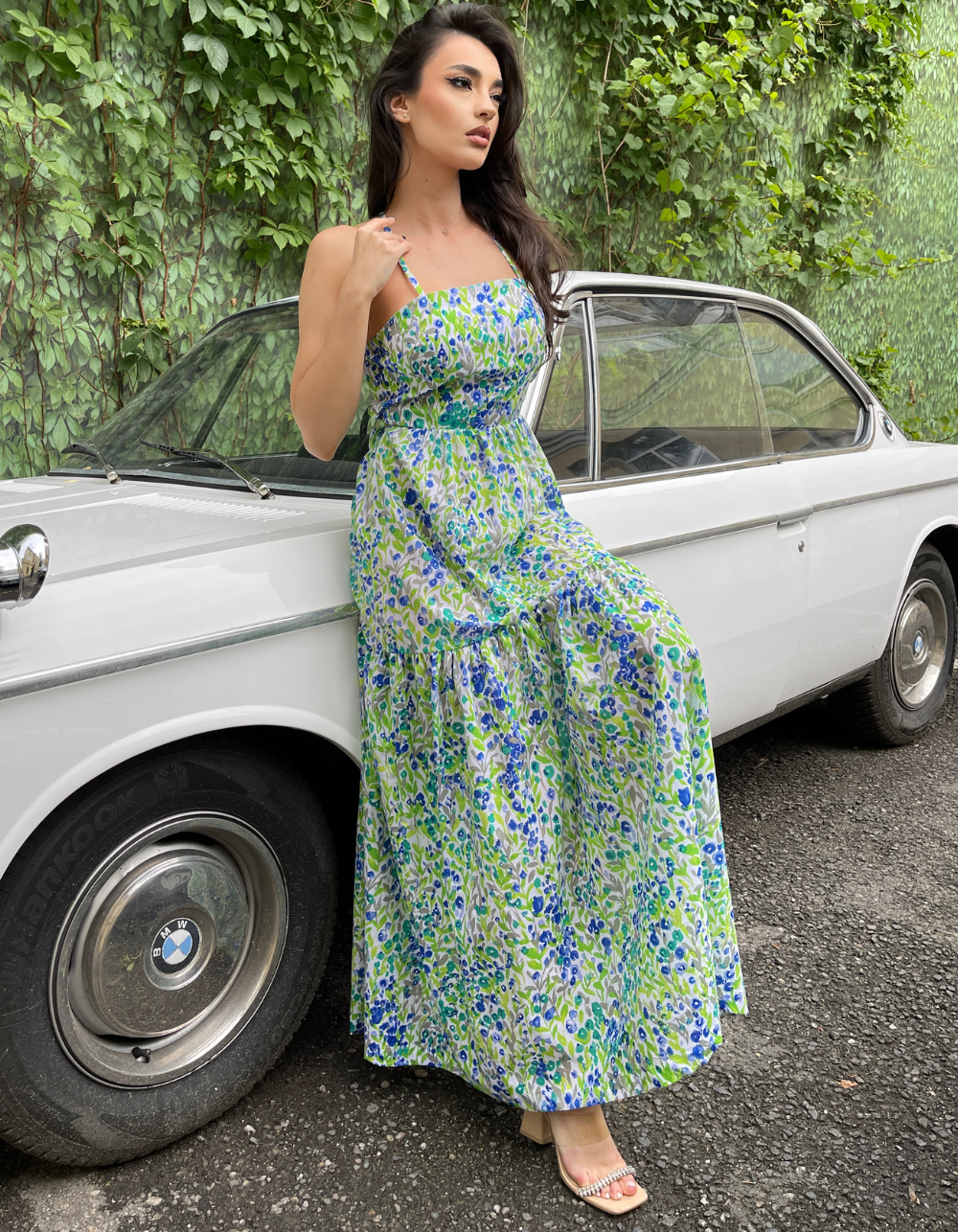 girls posing in a green floral apron dress