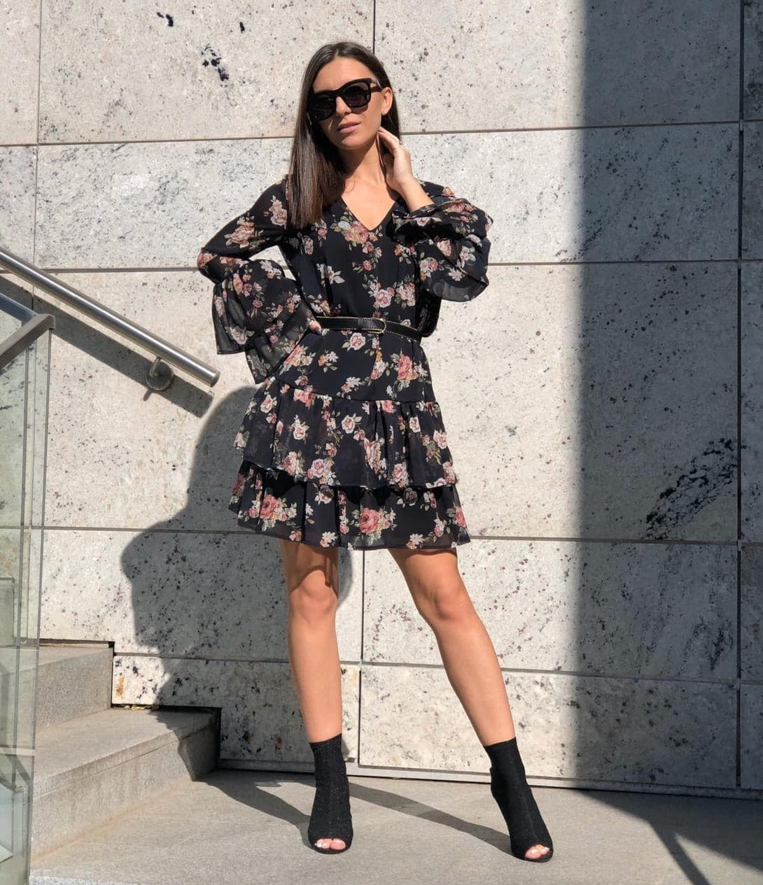 woman posing in a floral short dress