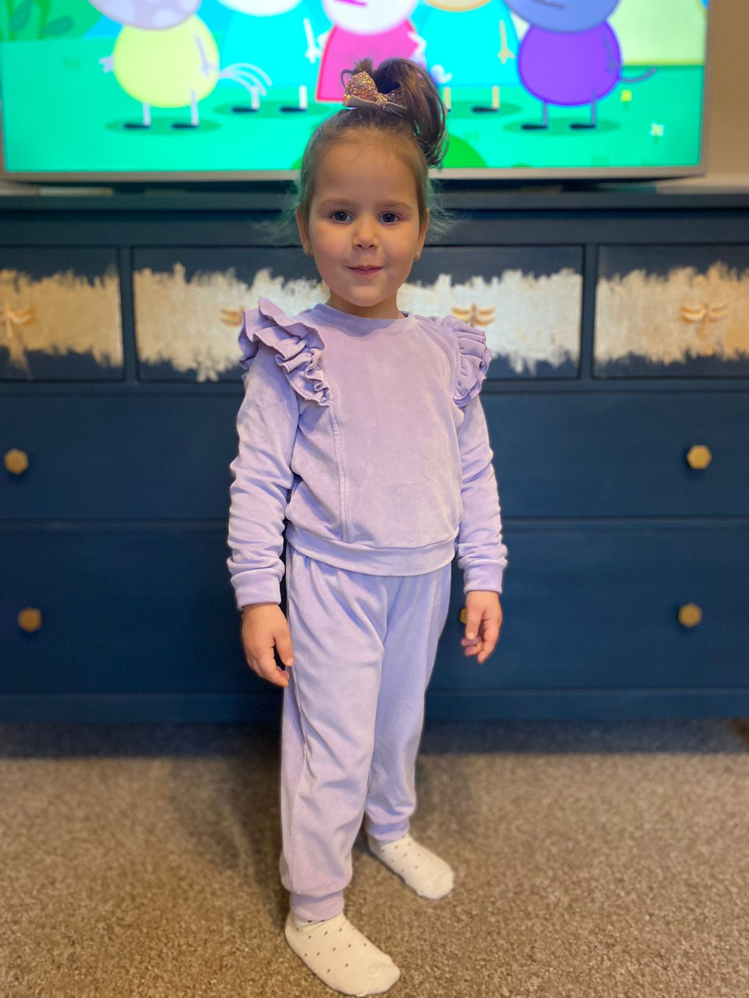 little girl posing in a lillac tracksuit