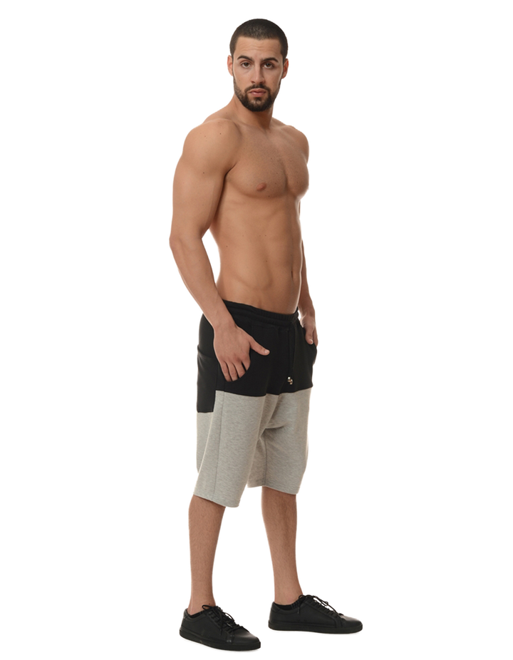 side view of a man posing in a pair of shorts