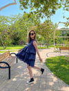 woman posing in a blue tiered dress